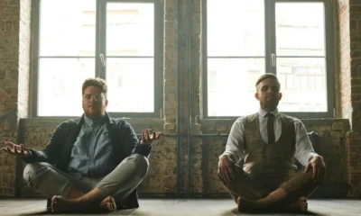 men sitting on floor, meditating