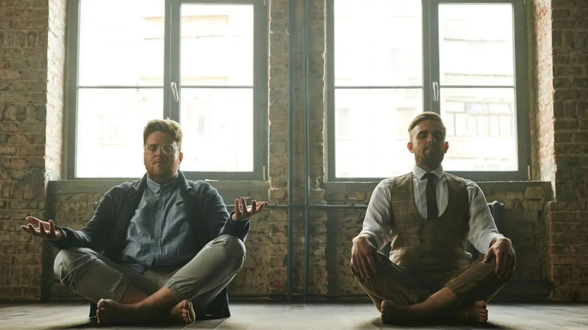 men sitting on floor, meditating